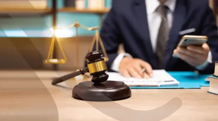 Legal professional reviewing documents on compliance and risk management in law office with gavel and scales of justice.